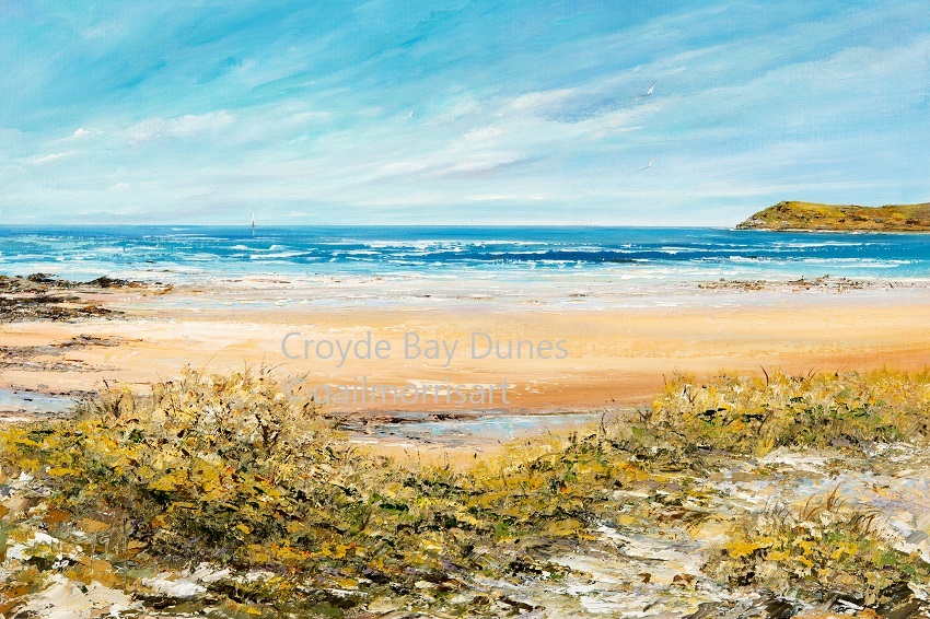 A print of Croyde Bay Dunes, depicting sandy shores and a blue sea under a clear sky, with vegetation in the foreground. Local landmark of Baggy Point in the distance.