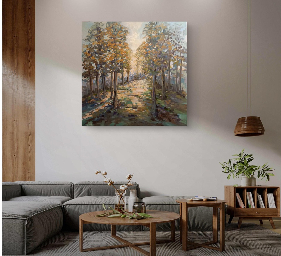 A modern living room featuring a cozy gray sectional sofa, a round wooden coffee table with decorative items, and a vibrant nature painting of a tree-lined path hanging on the wall.